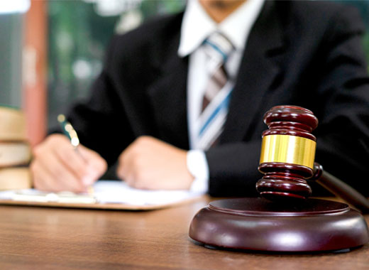 Judge writing behind a gavel