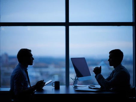 Two businessmen having a meeting next to a window